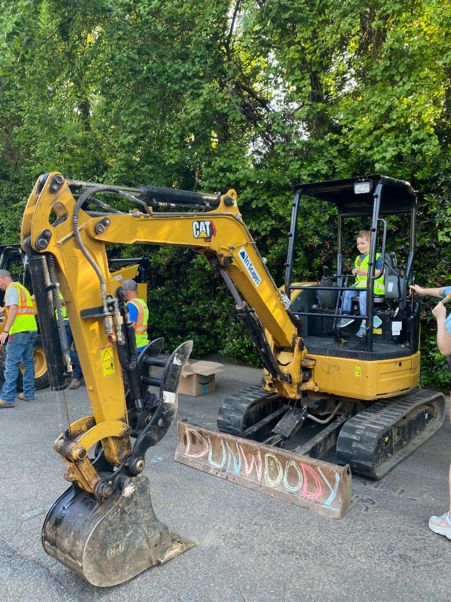 Little boy sitting in a backhoe
