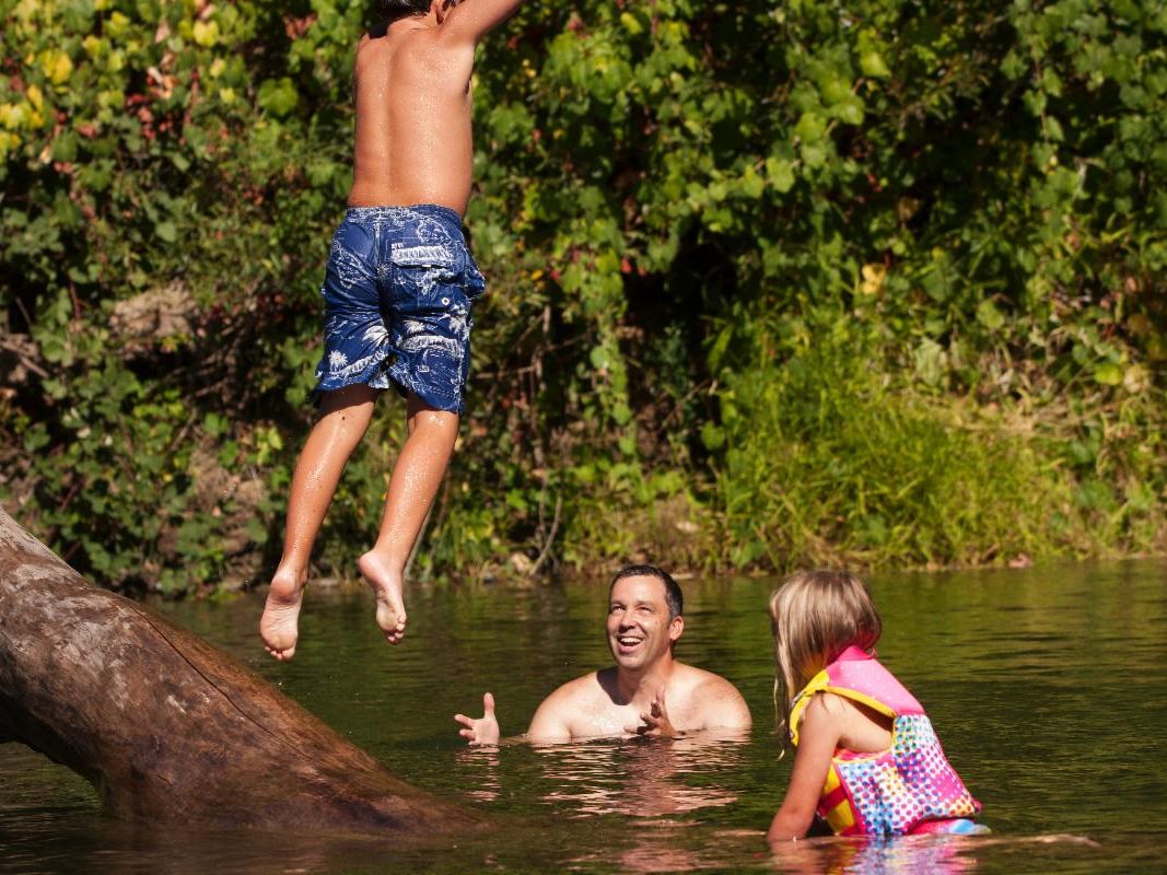 Boy jumps into river