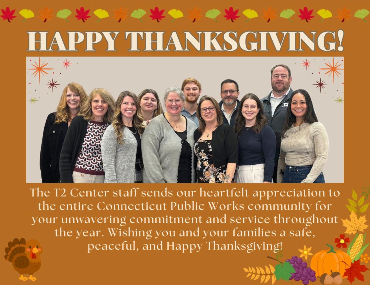 group photo of eleven T2 Center staff members standing together smiling with a Happy Thanksgiving banner and autumn-themed graphics around the border