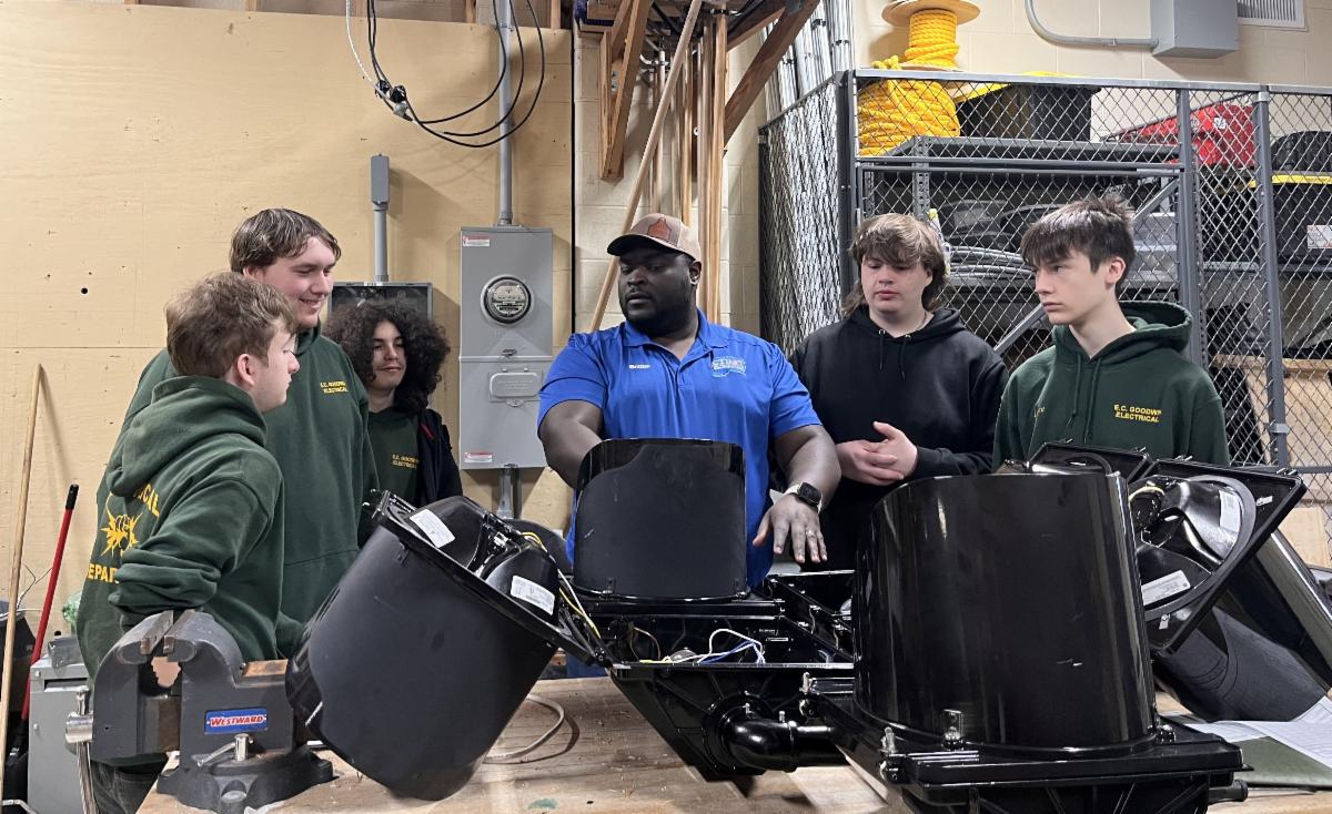 a group of people standing over traffic signals that are laying on a table