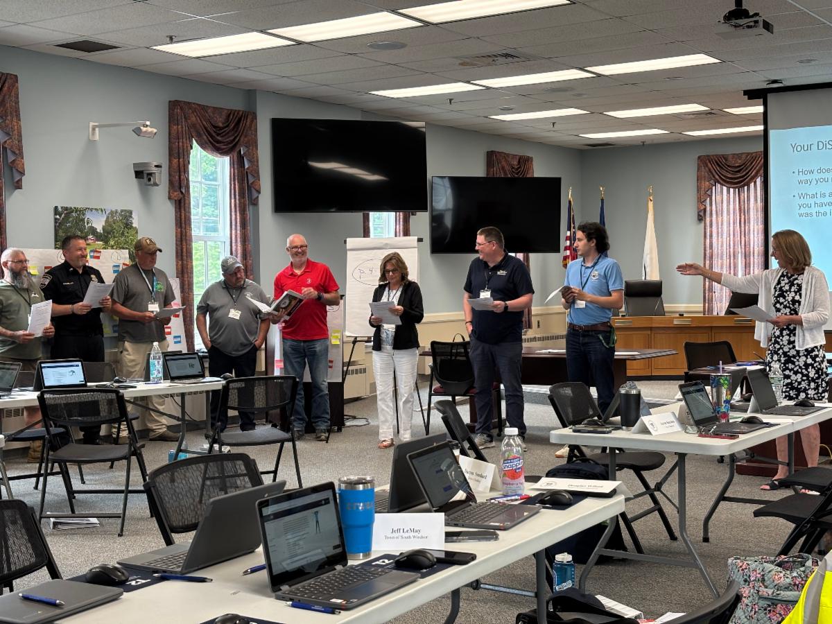 Participants standing around having a discussion about leadership in transportation