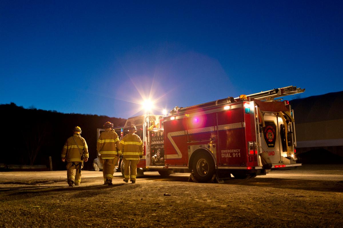 Firefighters walking towards a fire engine
