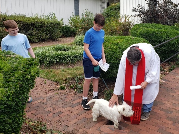 Here Will White and Cal White watch as Rick blesses Penny.