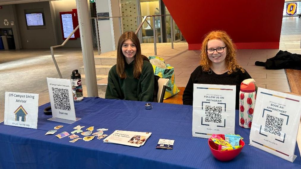 OCLA student team sitting at a booth with resources
