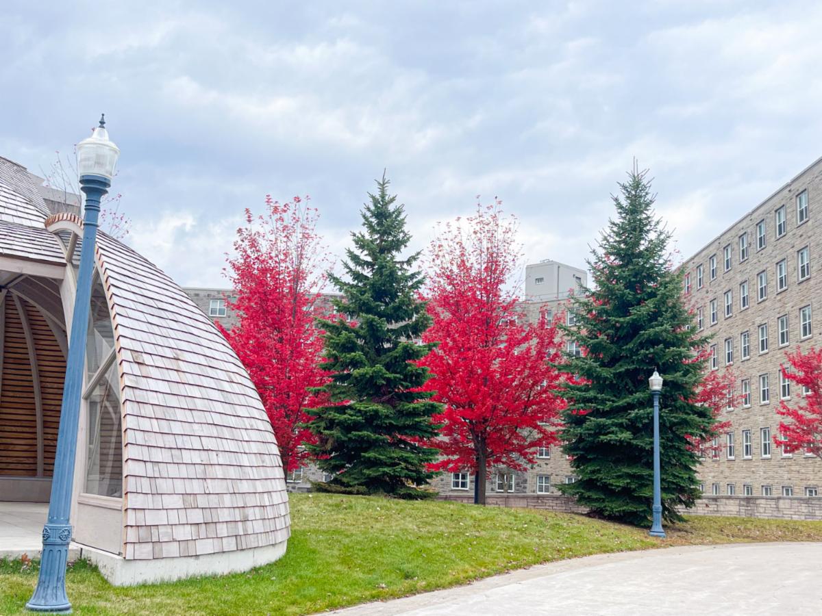 Victoria Hall in October with bright red trees and evergreens