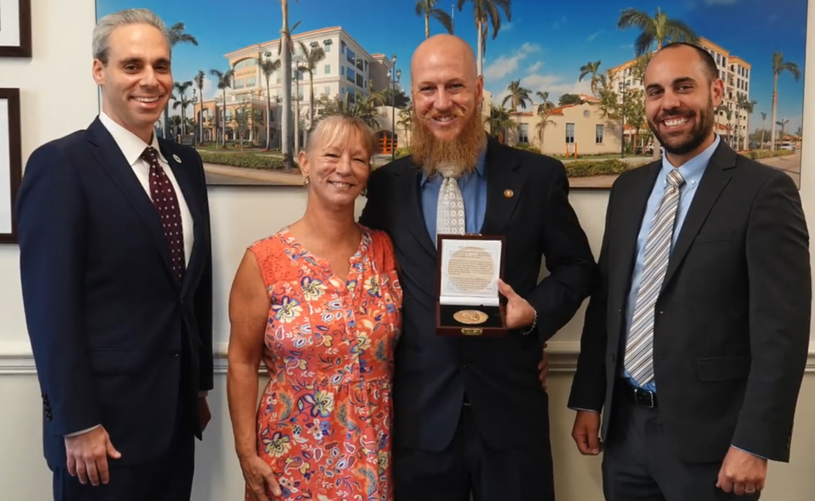 Mayor and Municipal Services Director presenting Shawn Turner with the Carnegie Medal