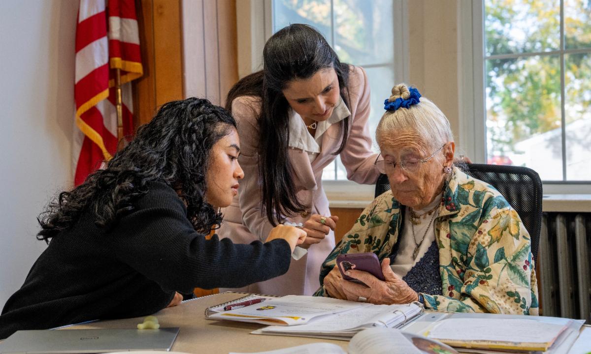 Dara LoBuono and a Rowan University student assist a participant in a nutritional education program for older adults.