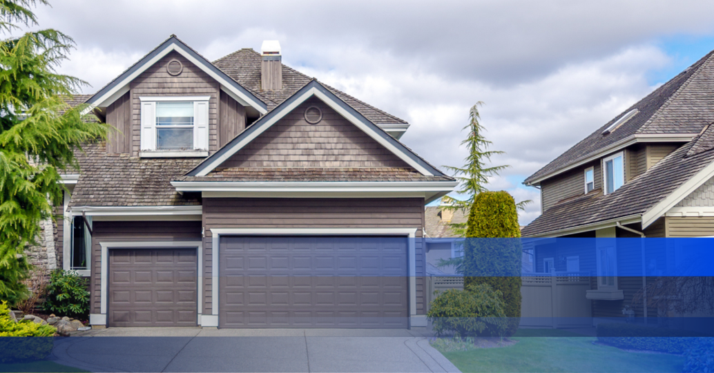 Exterior of a large grey home in a subdivision. 