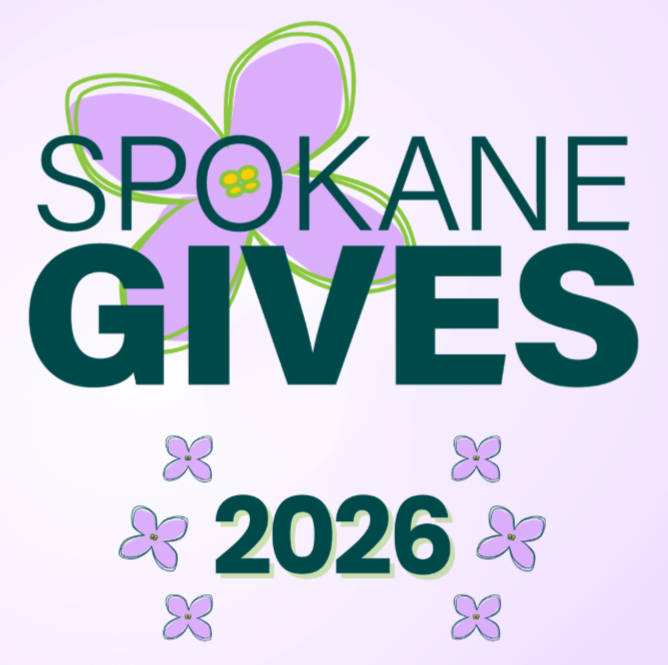 Green text reads "Spokane Gives" on top of a purple background with purple lilac flowers. 