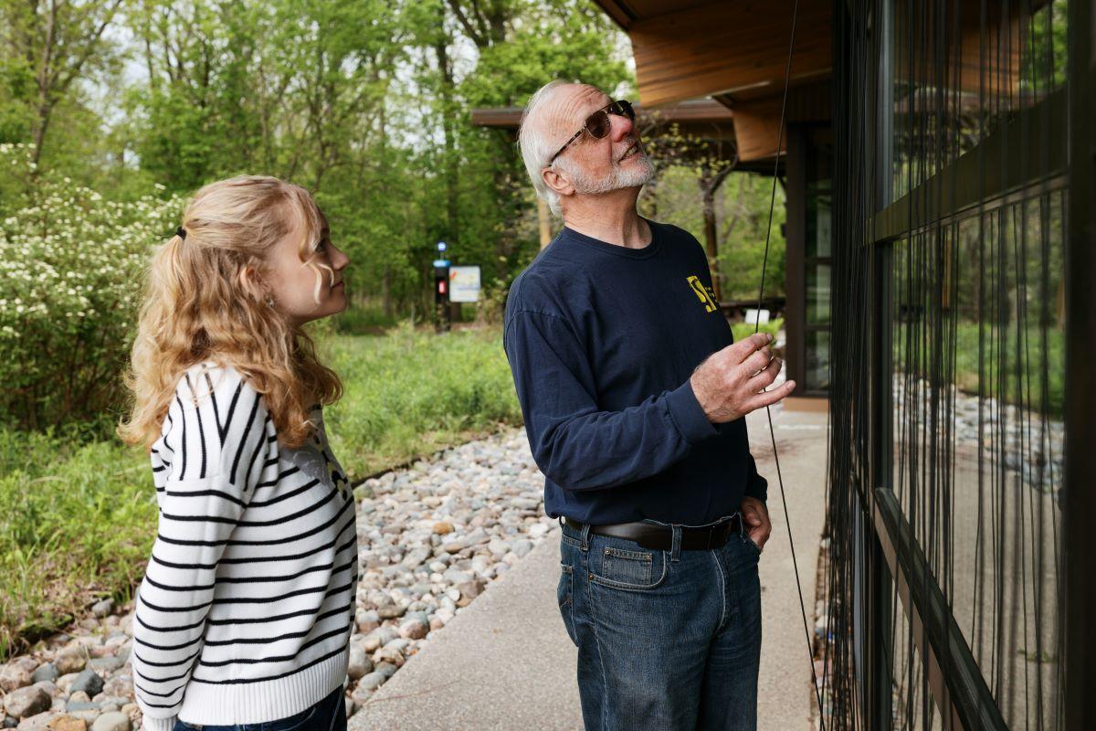 Rick Simek and Annah Frost examine the paracord obstacles designed to reduce bird/window collisions and fatalities.