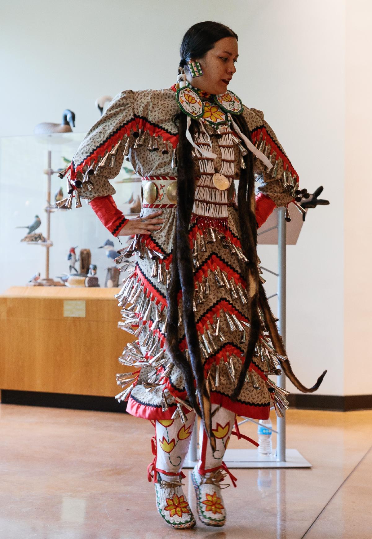 Indigenous storyteller and artist Hadassah Greensky in jingle dress regalia, dancing.