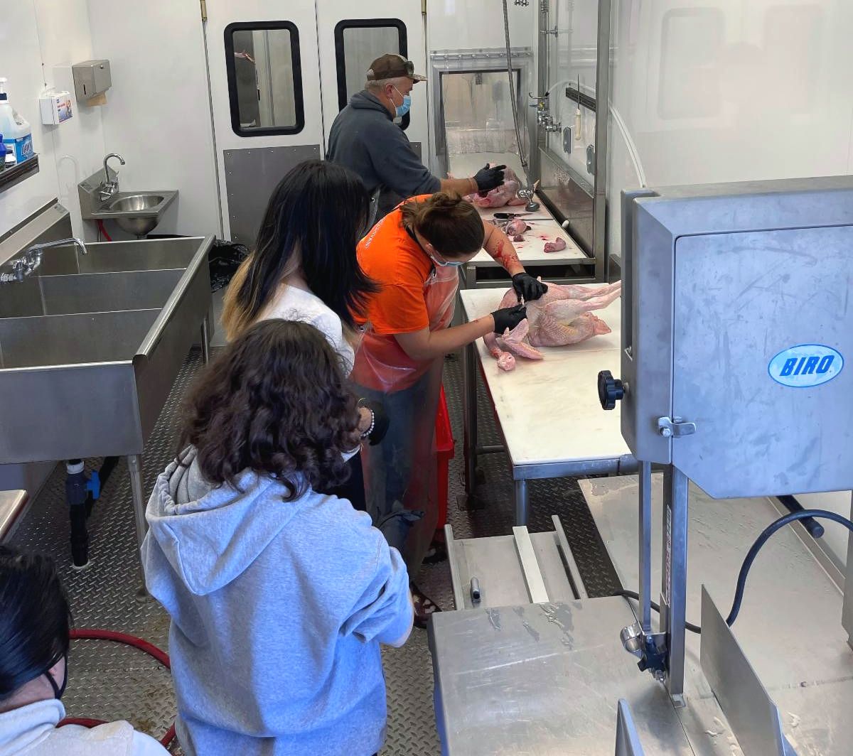 Individuals participate in Mobile Meat Processing Lab training.