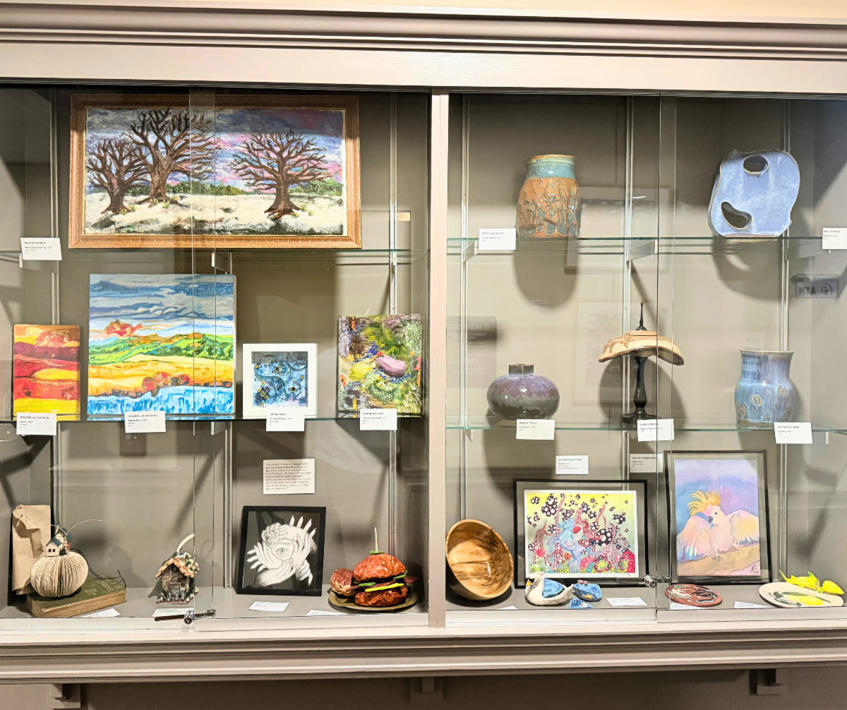 Sculptures and other art work in a display case behind glass at City Manchester