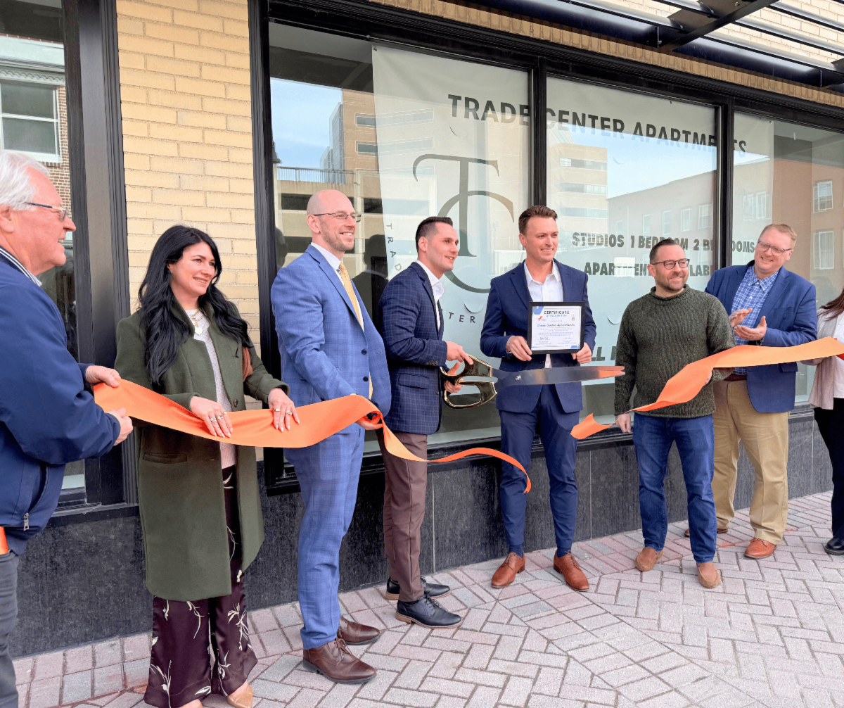 A group of individuals celebrating a ribbon cutting