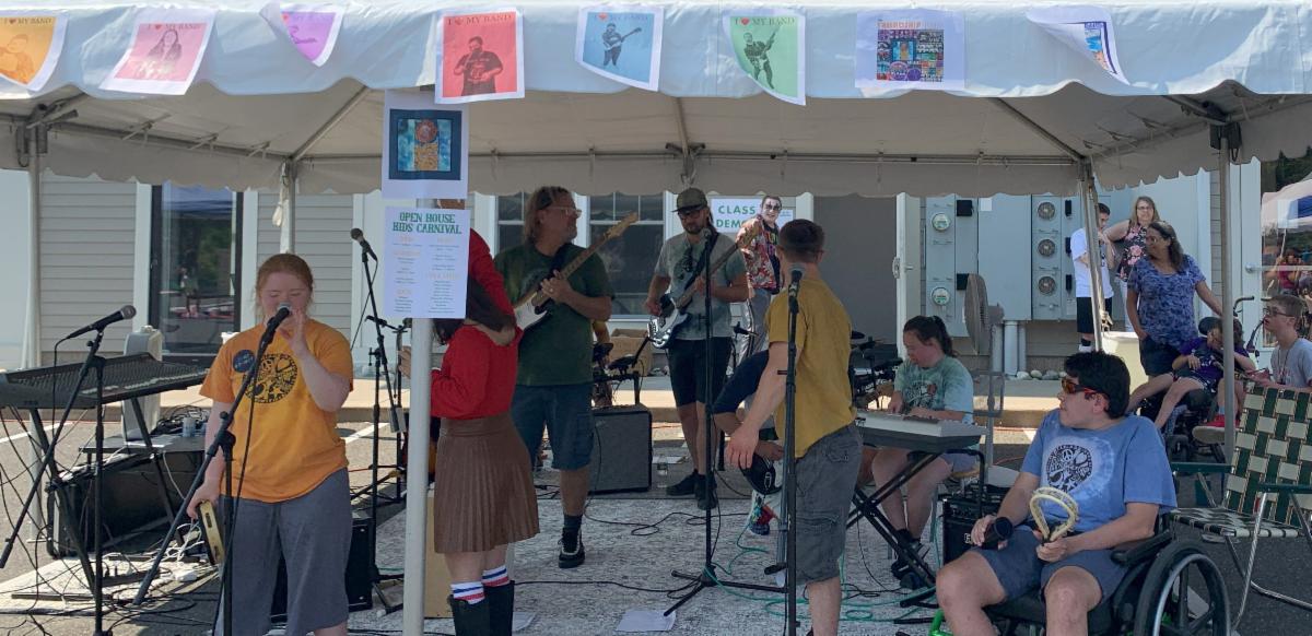Friendship Band playing outside under a tent