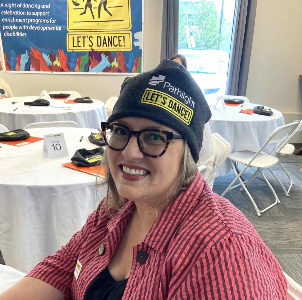 Let's Dance community dancer and Northampton Mayor Gina-Louise Sciarra wearing her Let's Dance branded hat. Hat is gray beanie with yellow logo that says Pathlight Let's Dance
