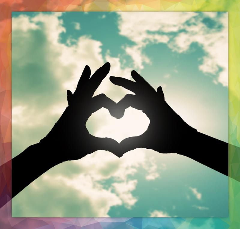 two hands making a heart shape in the sky cross processed