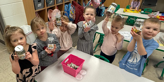 children at the ECC show their banks