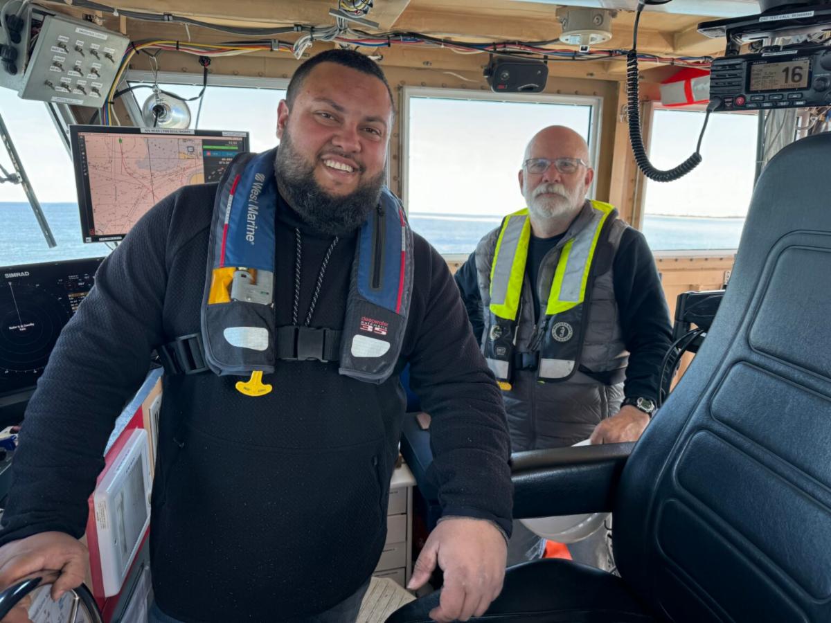 Virgilio Gonzalez and Jim Nickels standing in a vessel wheelhouse.