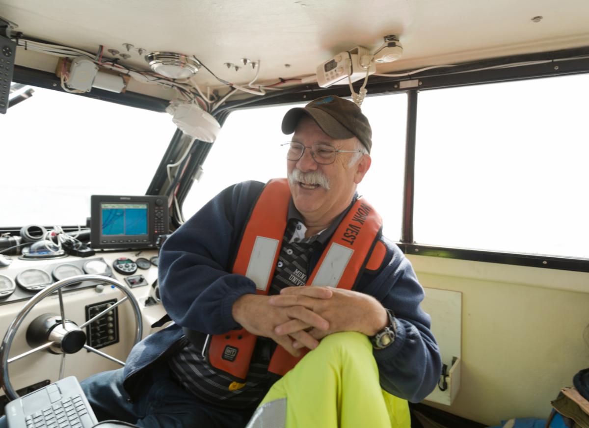 Jim Nickels seated in a vessel wheelhouse
