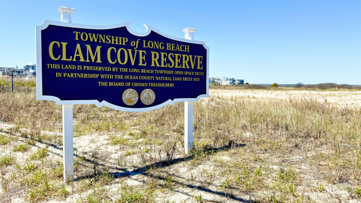 A sign on a marsh area reading Township of Long Beach Clam Cove Reserve