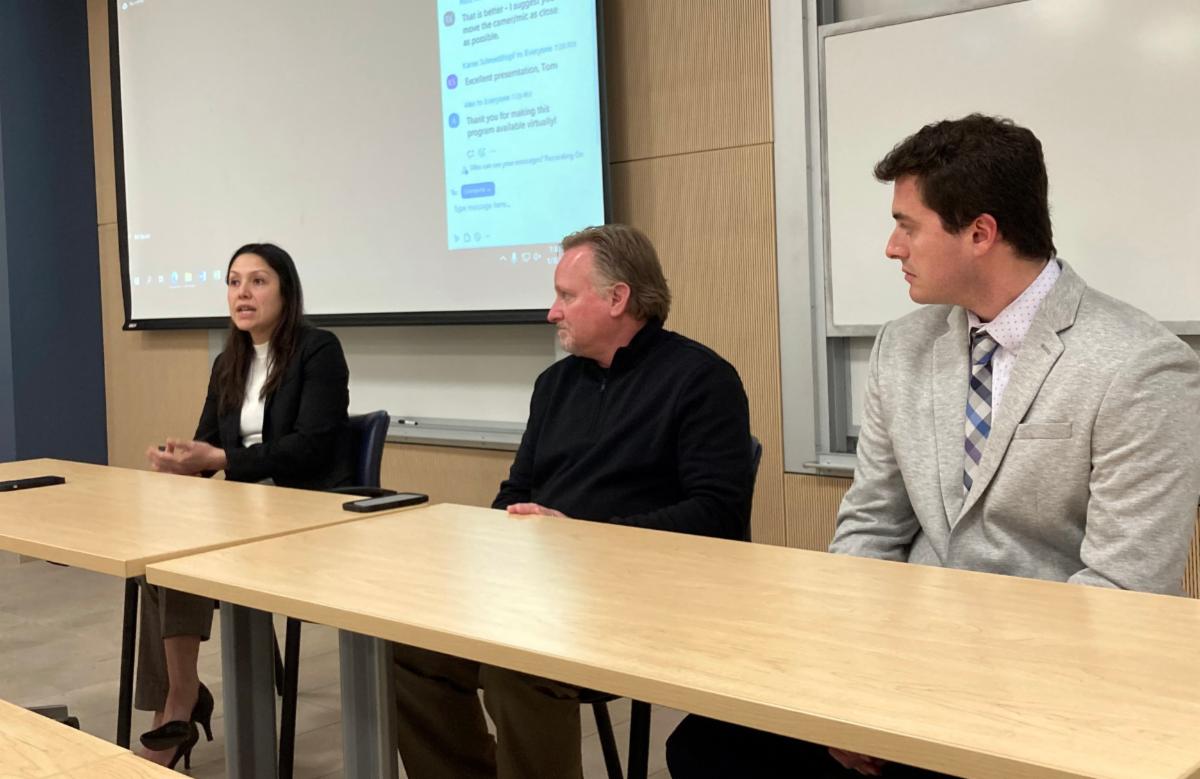 Panelists Gina McKeever, Tom Herrington and Matt Paccico seated at a table