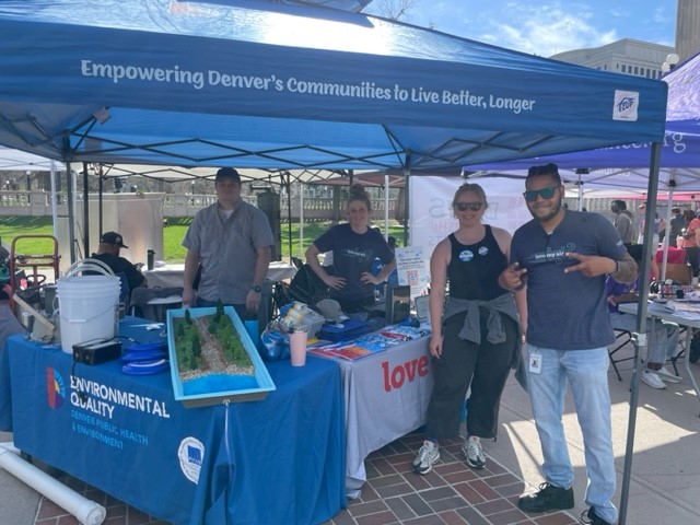 Group of people standing at event table smiling