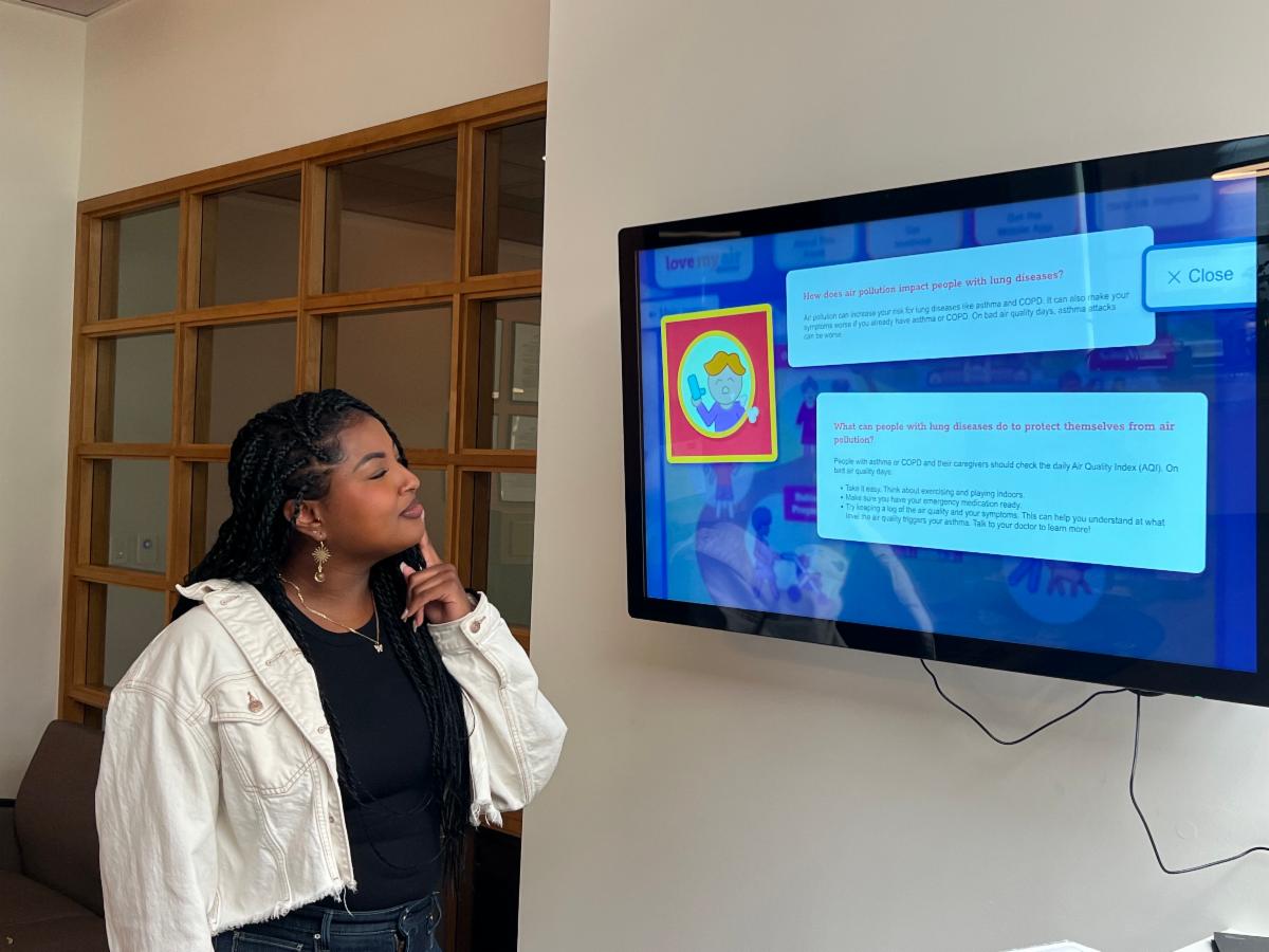 Person looking at screen showing air quality information