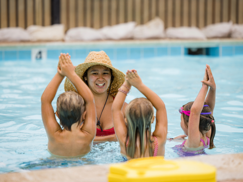A child swims with an instructor.