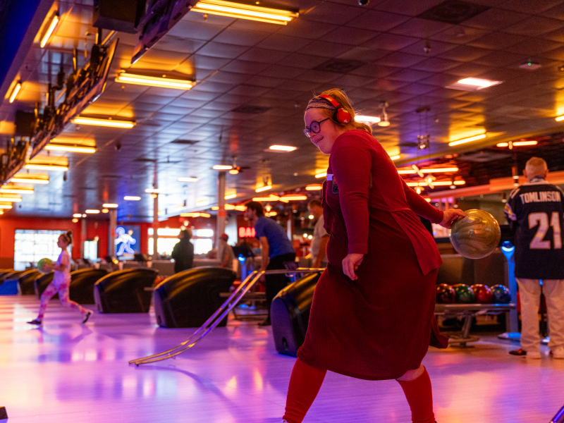  bowling league participant prepares to roll a bowling ball down the lane