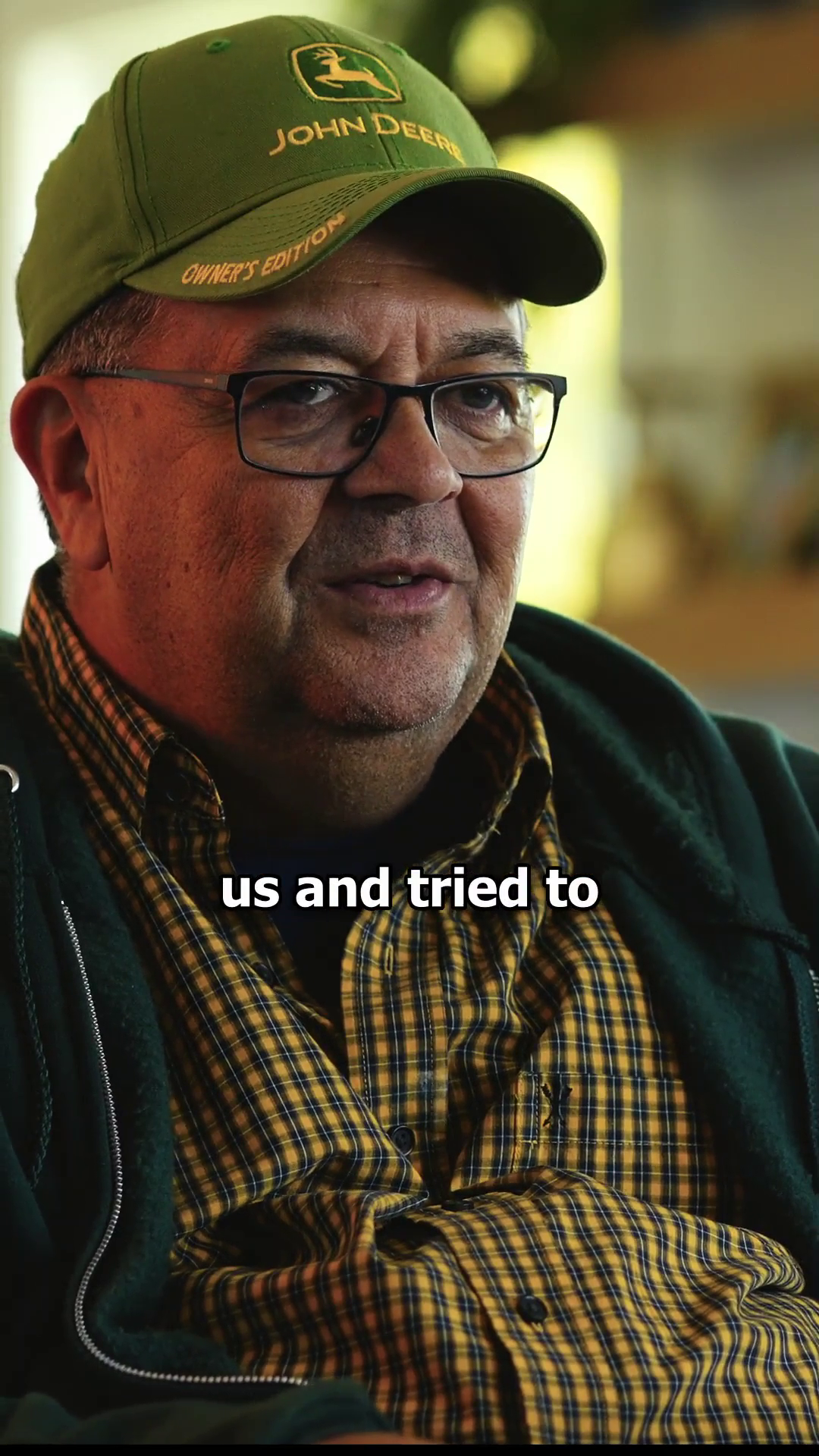 Headshot of Ed Bell talking while wearing John Deere ball cap