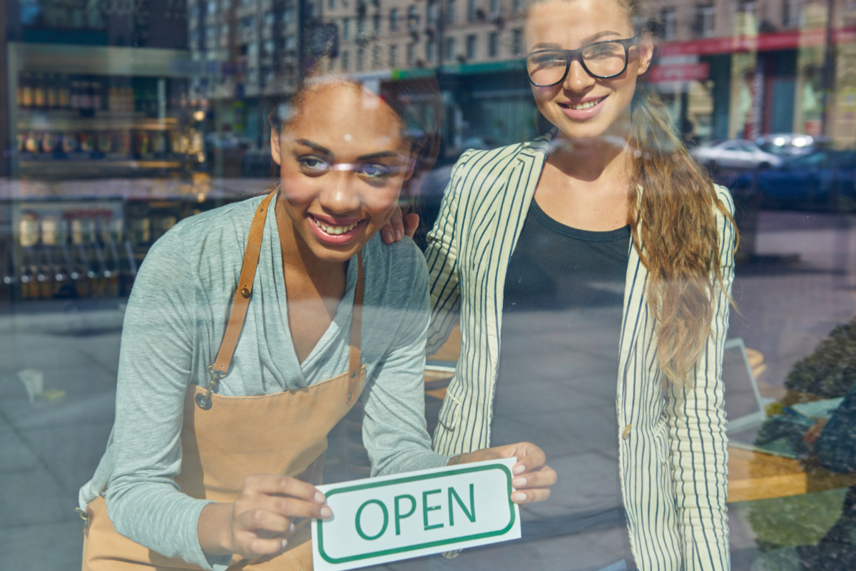 women holding open sign
