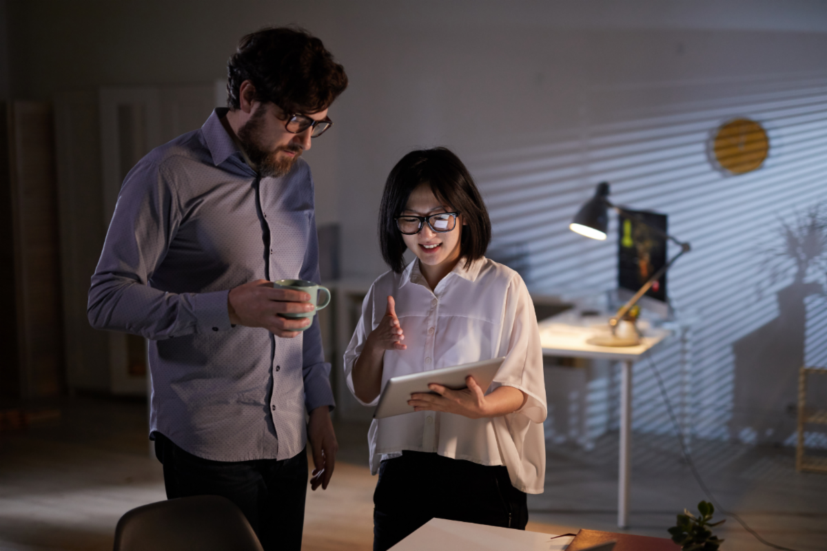 Man and Woman Looking at IPad