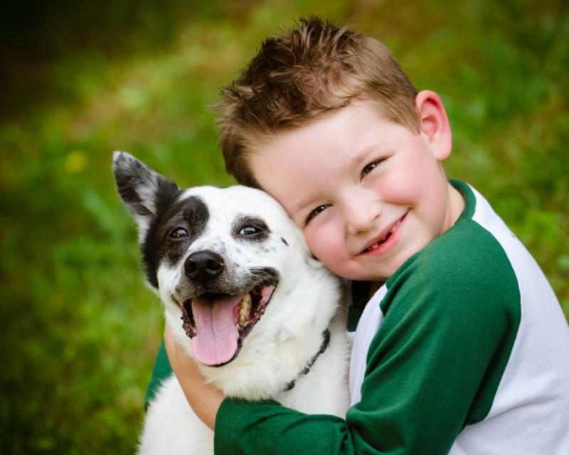 kid_hugs_black_white_dog.jpg