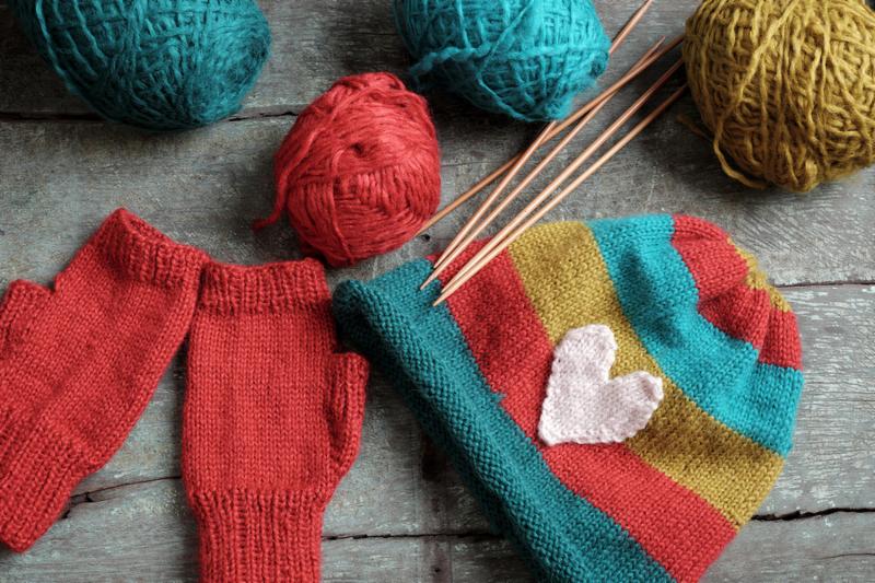 Handmade gift for winter knitted gloves and knit hat for cold day group of colorful yarn make warm knit accessories is hobby activity of woman