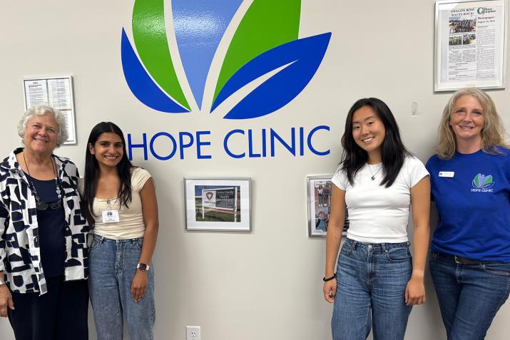 Staff and students in front of Hope Clinic sign