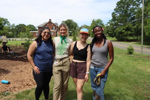 PA students standing in front of garden