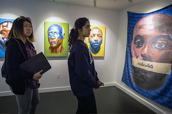 Duke students take in an antiracism art piece during a workshop activity in 2019