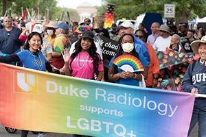 Women holding sign that says "Duke Radiology Supports LGBTQ+"