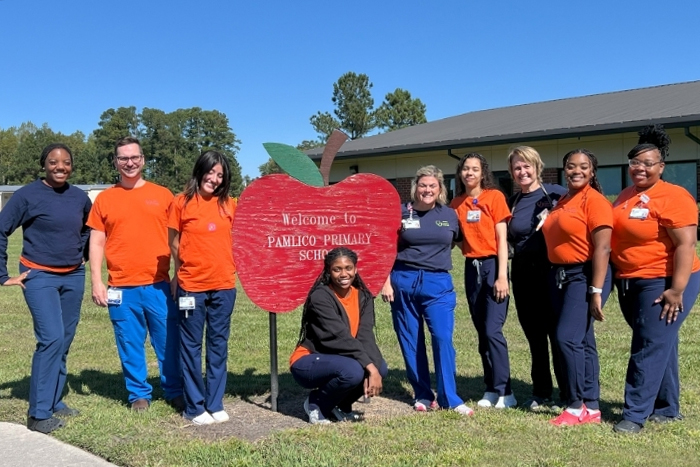 Nursing students in front of Pamlico County Primary School sign