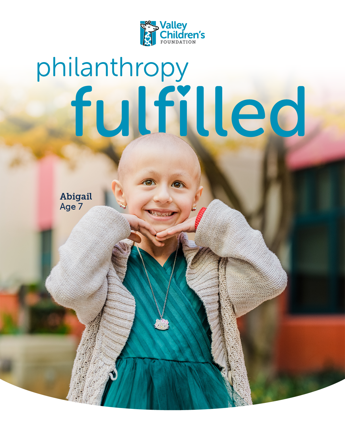 Abigail a smiling girl holds her hands under her chin.