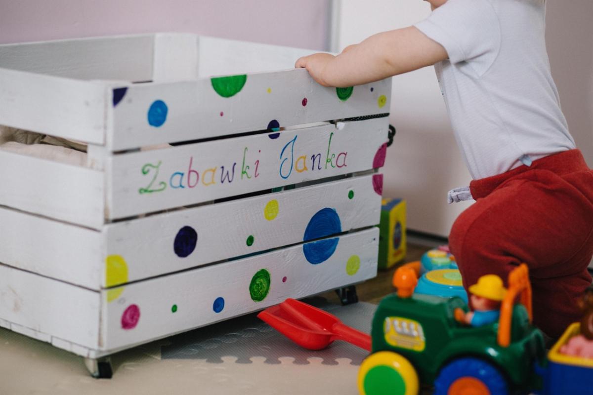 Toddler playing with toys in a toy box