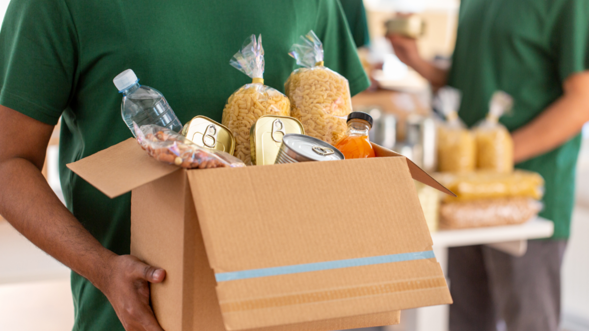 Man holding box of food and non-perishables