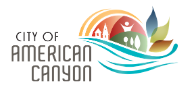 City of American Canyon logo. Modern style font is used to show the city's name. Graphic next to it has imagery of homes, trees, and a person. Wave like illustrations blend together representing water, sun, hills and trees. 