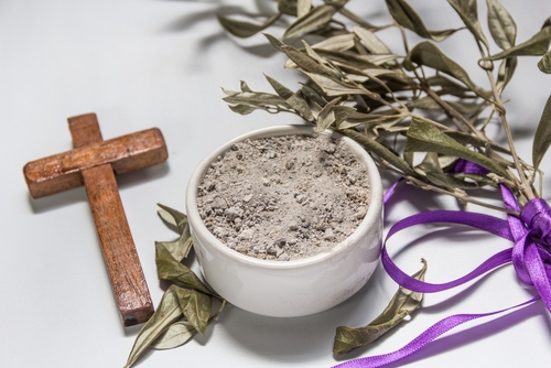 Bowl with ashes_ olive branch and cross_ symbols of Ash Wednesday