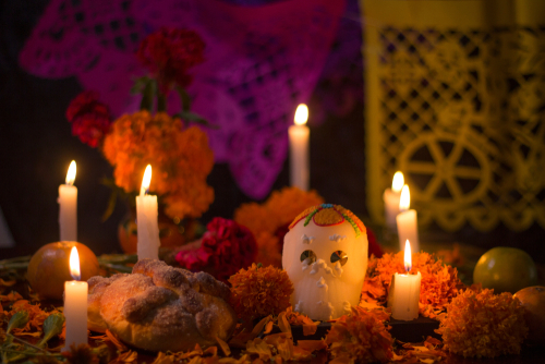 Day of the dead Sugar skull with candles_ bread and flowers altar decoration at Janitzio_ Michoacan