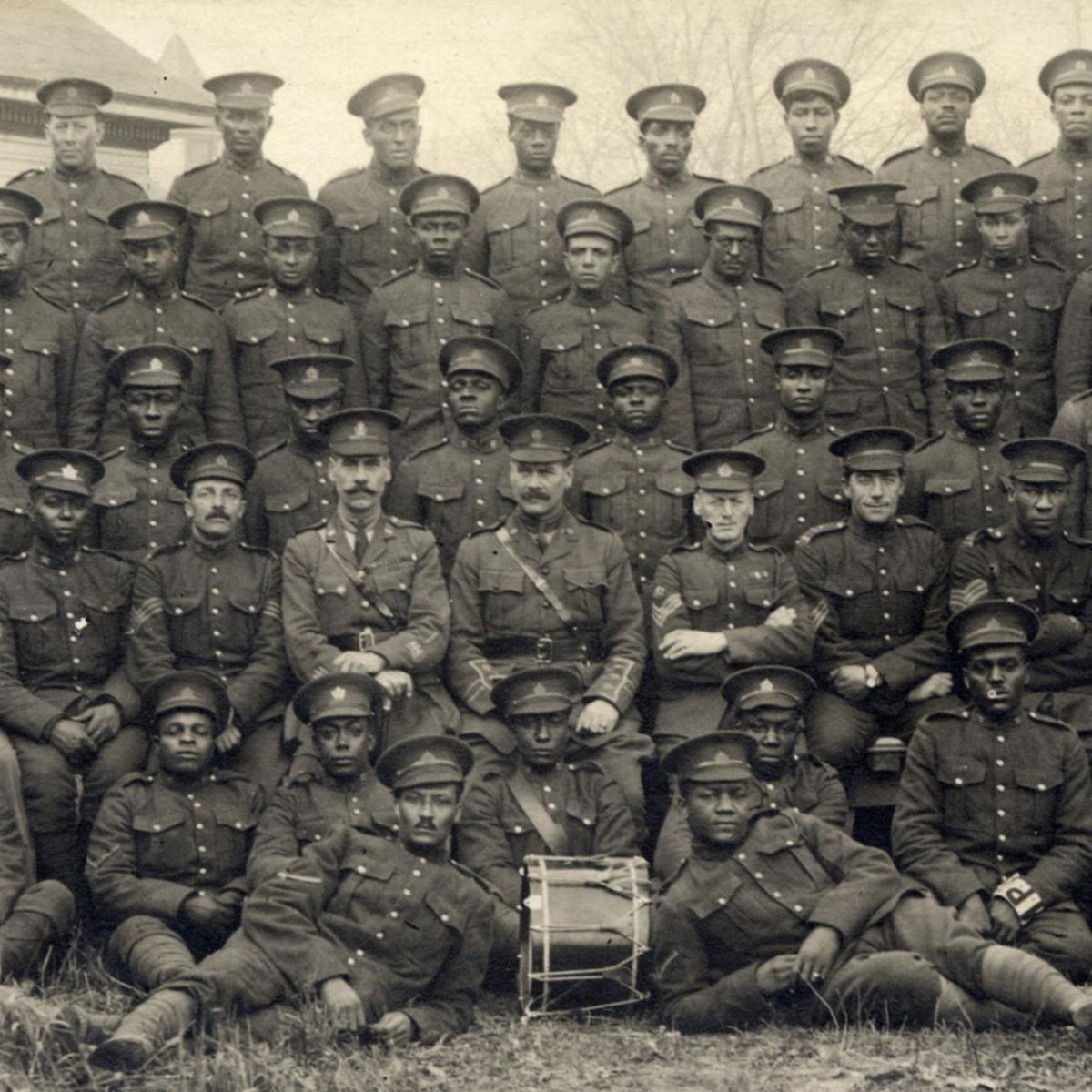 Black and white photograph of the officers and men of the No. 2 Construction Battalion; there are five rows of men in the photograph, the majority of who are black.