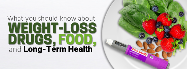 A plate containing leafy greens, berries, almonds, and an injectable weight-loss drug