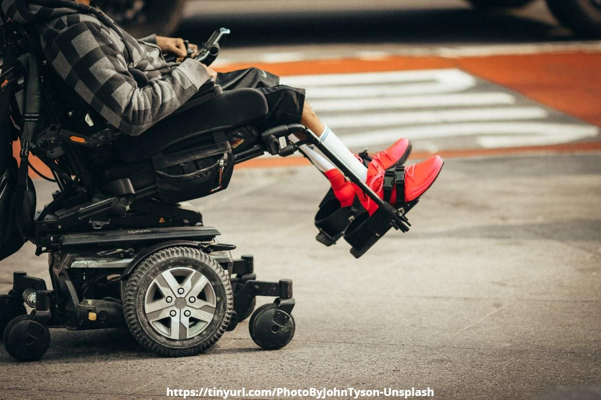 Person in Motorized Wheelchair Crossing the Street