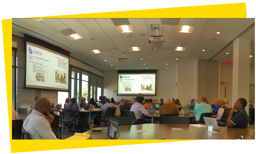 Stakeholders meet at a Georgia AIM meeting to listen to important updates. 